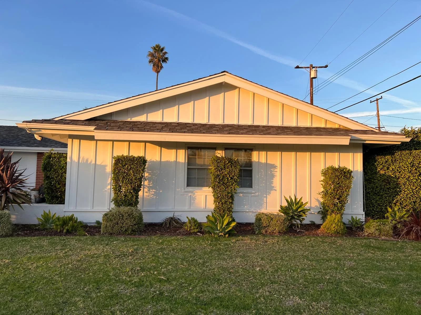 A freshly painted single-story home exterior in San Juan Capistrano at golden hour