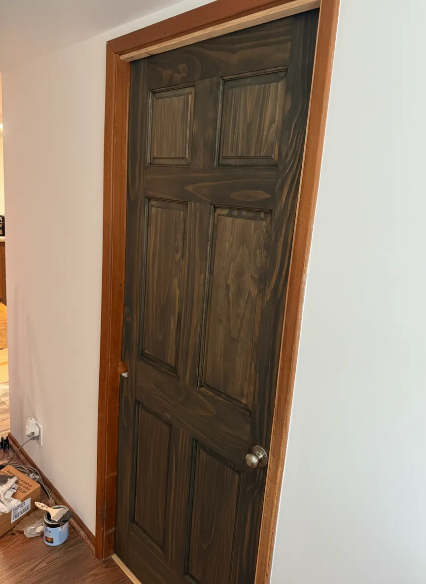 A metal door refinished to look like stained hardwood